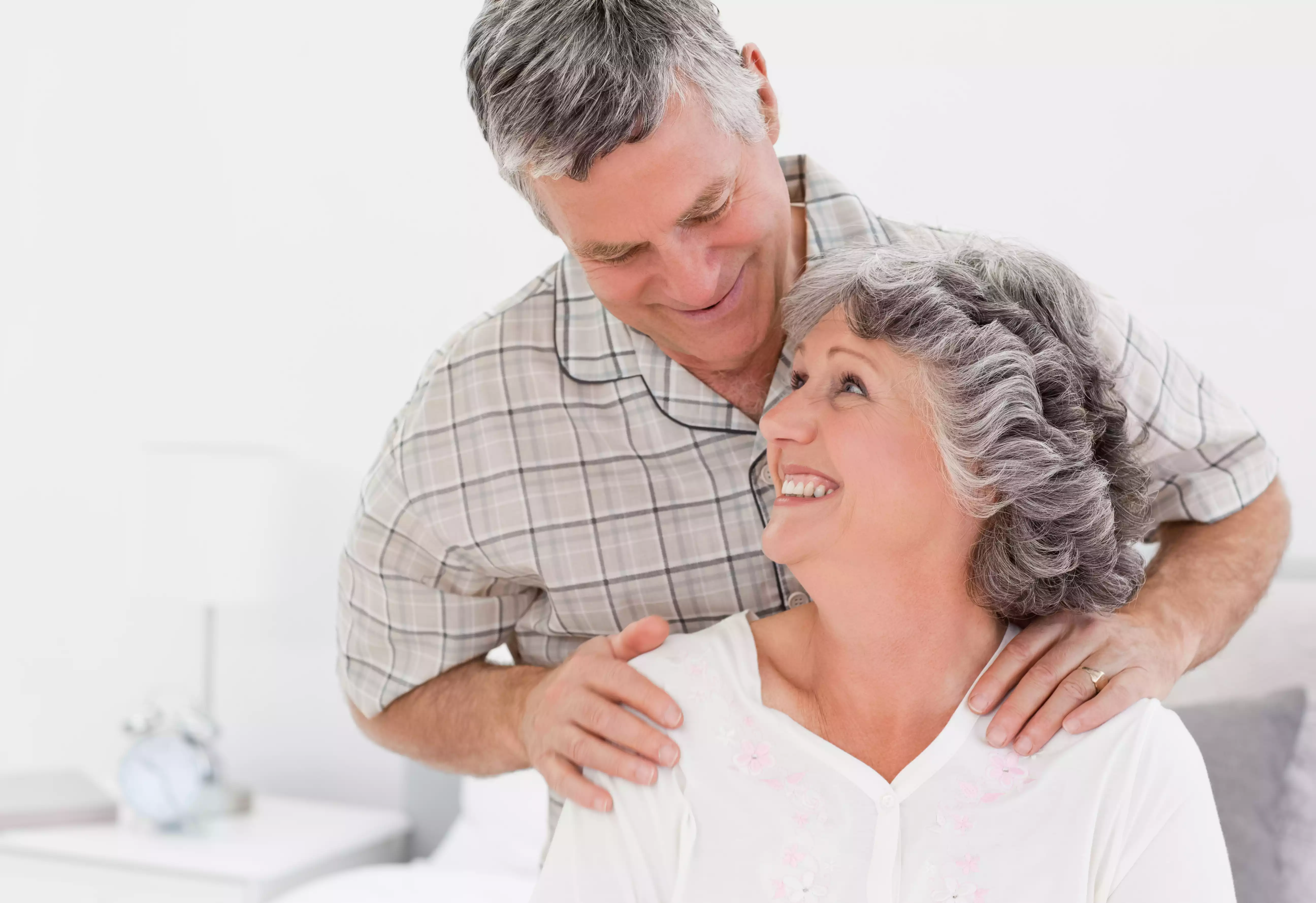 Man giving shoulder massage woman smiling
